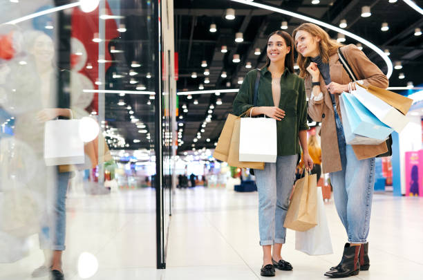 istock Young women choosing clothes in mall 1211942208