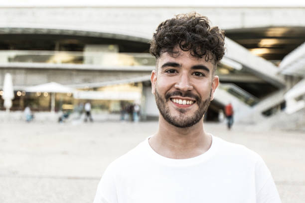 istock Happy carefree guy posing in city square 1211944206