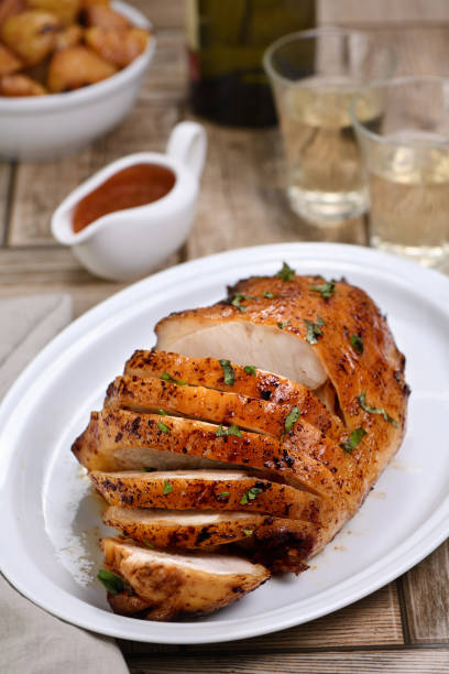 istock Sliced into slices baked turkey breast close-up at the dinner table 1211944231