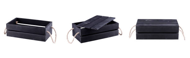 istock Three black wooden crates. A step of three boxes open half open and closed. 1211945957