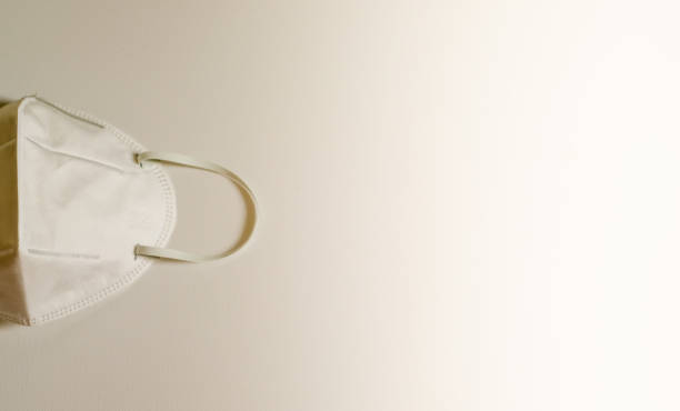 istock Closeup of surgical medical particulate protective white mask on white background. using for heathcare and sanitary concept with copy space for text. 1211946788