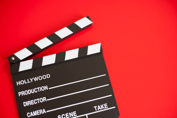 istock film clapper and pen notepad on red background 1211946833