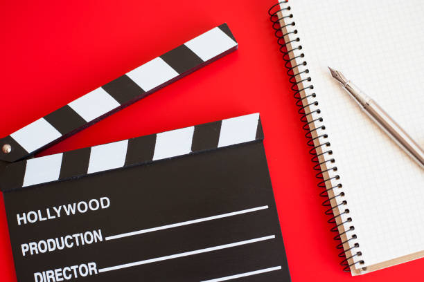 istock film clapper and pen notepad on red background 1211946836