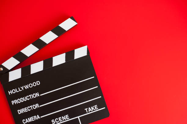 istock film clapper and pen notepad on red background 1211946837