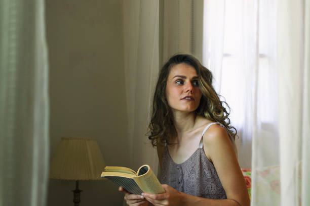 istock Pretty Woman Reading a Book 1211946934