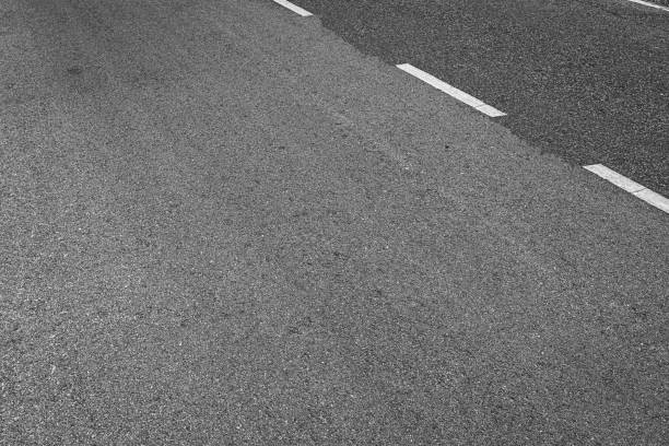 istock Asphalt road with marking lines white stripes texture Background. 1211948174