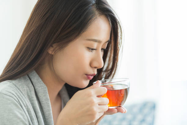 istock Young woman drinking tea 1211948260
