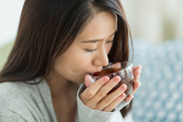 istock Young woman drinking tea 1211948282