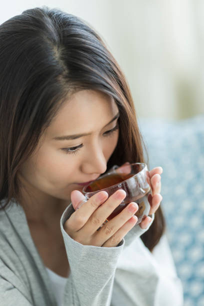 istock Young woman drinking tea 1211948293