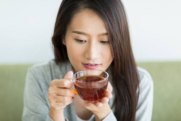 istock Young woman drinking tea 1211948296