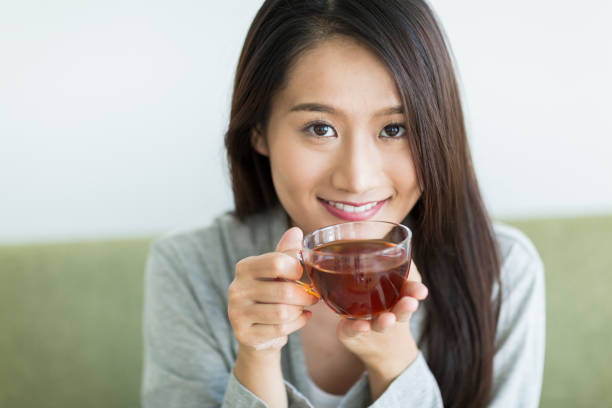 istock Young woman drinking tea 1211948297