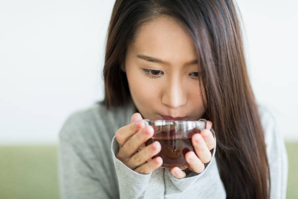 istock Young woman drinking tea 1211948300