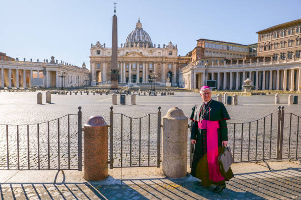 A catholic cardinal in St. Peter's Square closed and deserted due to the Covid-19 lockdown Vatican, Italy, March 11 -- A Catholic cardinal in front of the square of St. Peter's Basilica completely deserted after the ban on access to tourists and pilgrims. church of san pietro photos stock pictures, royalty-free photos & images