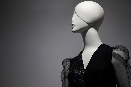 Female mannequin on a gray background.