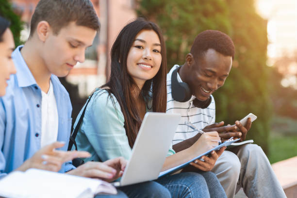 istock Happy Teens International Students Studying Together Outdoors, Enjoying University Life 1211948688