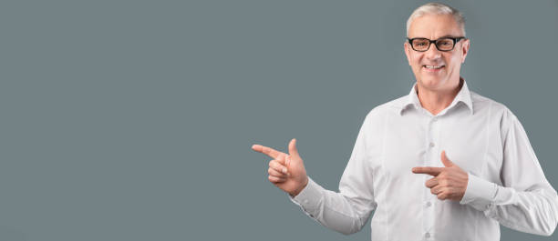 istock Smiling man pointing fingers at free space 1211949401