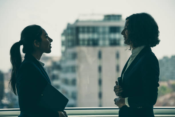 istock Confident female business colleagues discussing project 1211949614