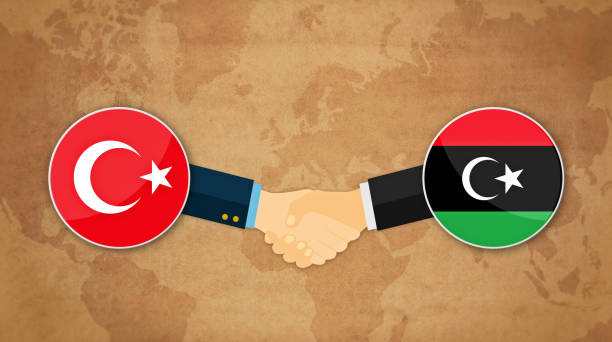 ilustraciones, imágenes clip art, dibujos animados e iconos de stock de cooperación entre turquía y libia. apretón de manos listo con banderas de fondo dibujos animados - libyan flag