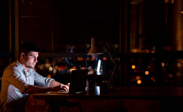 istock Entrepreneur Guy Working On Laptop Creating Startup Overnight In Office 1211950706