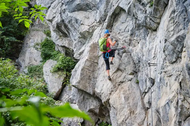 Photo of Woman climbing via ferrata Zimmereben, near Mayrhofen, Zillertal valley, Austria.