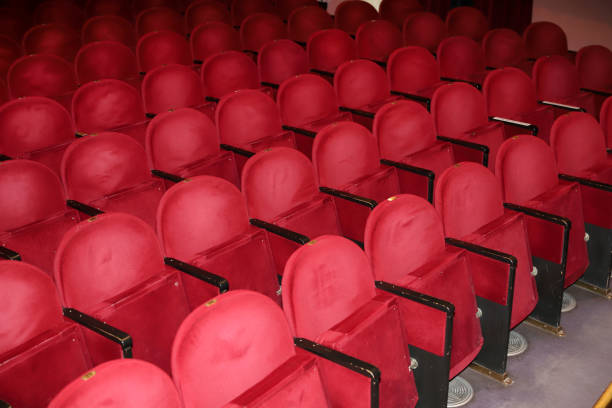 istock Classic rows of empty reddish seats in theatre 1211950946