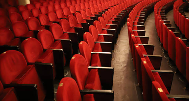 istock Classic rows of empty reddish seats in theatre 1211950977