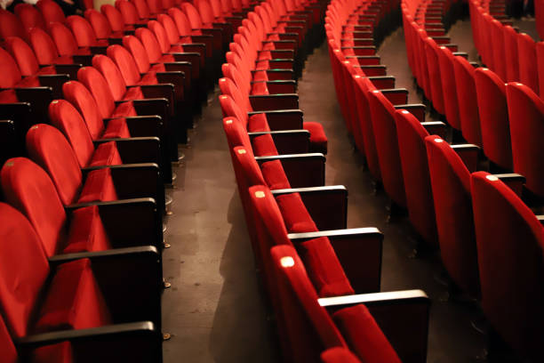 istock Classic rows of empty reddish seats in theatre 1211950987