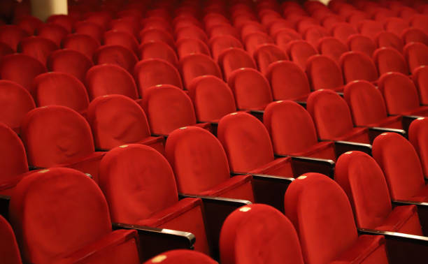 istock Classic rows of empty reddish seats in theatre 1211950989