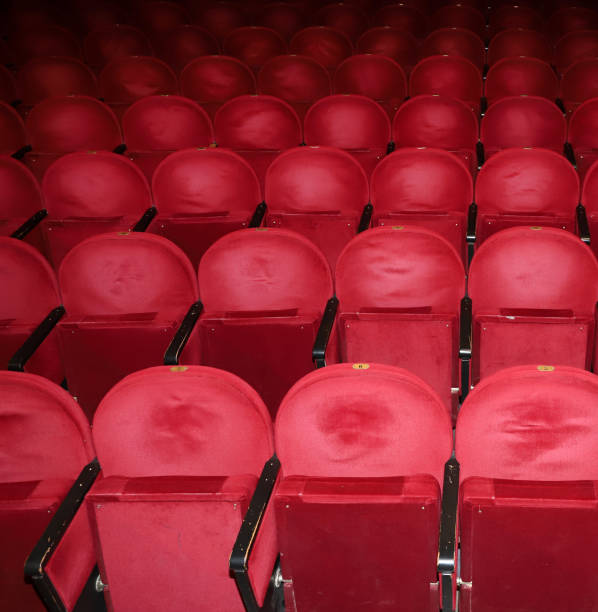 istock Classic rows of empty reddish seats in theatre 1211951099