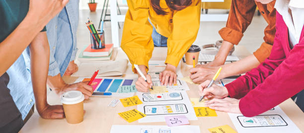 Young Asian business creative team work together, mobile application software design project. Brainstorm meeting, internet technology, smartphone web app designer, office coworker teamwork concept equipo creativo de negocios asiáticos jóvenes trabajan juntos, proyecto de diseño de software de aplicaciones móviles. reunión de lluvia de ideas, tecnología de internet, diseñador de aplicaciones web para teléfonos inteligentes, concepto de trabaj
