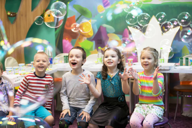 istock Soap bubbles show. Children's party. To burst the soap bub 1211952676
