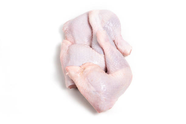 Raw chicken thigh on white background stock photo