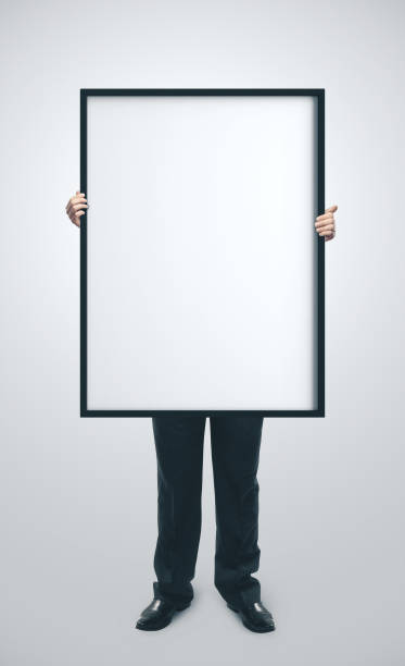 istock Businessman holding blank poster 1211955280
