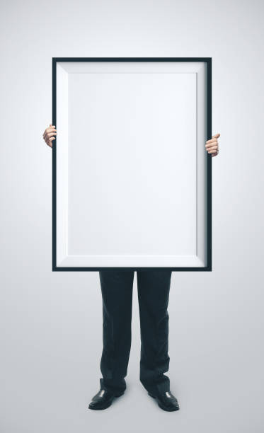 istock Businessman holding blank poster 1211955669