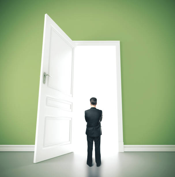 istock Businessman standing in green room 1211955744