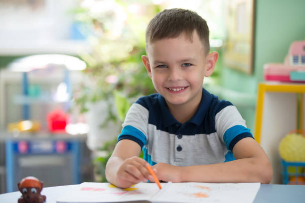 istock A contented child in a kindergarten on a drawing draws 1211955952