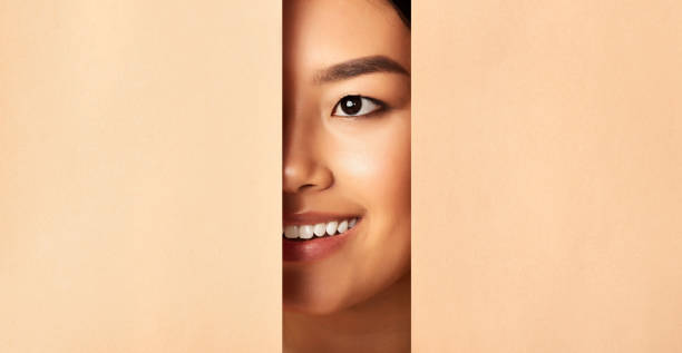 istock Unrecognizable Asian Girl Smiling Looking Through Beige Papers, Panorama 1211956774