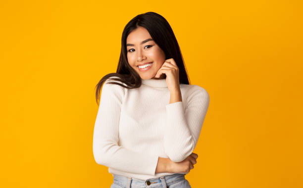 istock Asian Girl Posing Touching Face Smiling To Camera, Studio Shot 1211956844