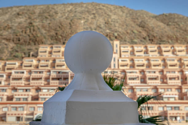 Architectural detail in front of out of focus hotel building at sunset