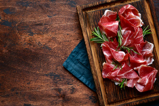 istock Slices of prosciutto di parma or jamon serrano (iberico) 1211960936