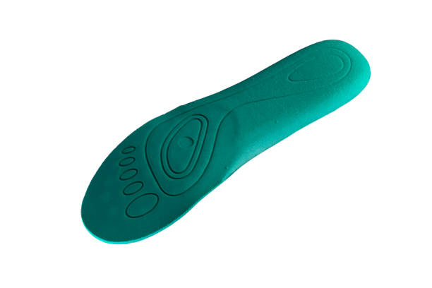 istock Green orthopedic insole on a white background 1211961177
