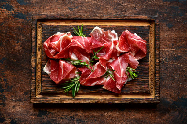 istock Slices of prosciutto di parma or jamon serrano (iberico) 1211961212