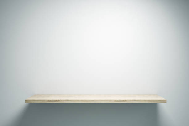 istock Empty light wooden shelf on gray wall. 1211961241