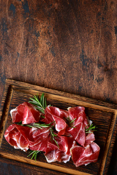 istock Slices of prosciutto di parma or jamon serrano (iberico) 1211961840