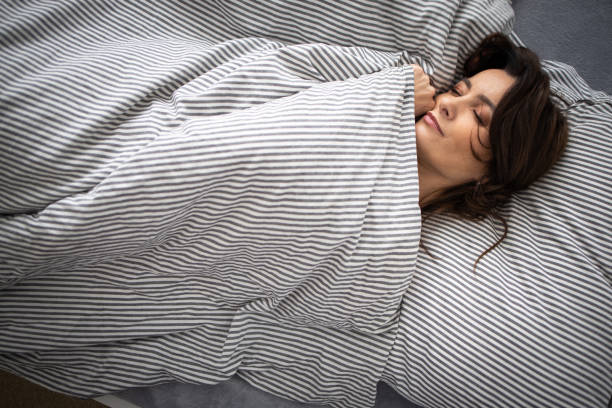 istock Pretty, young woman in her bed 1211962416