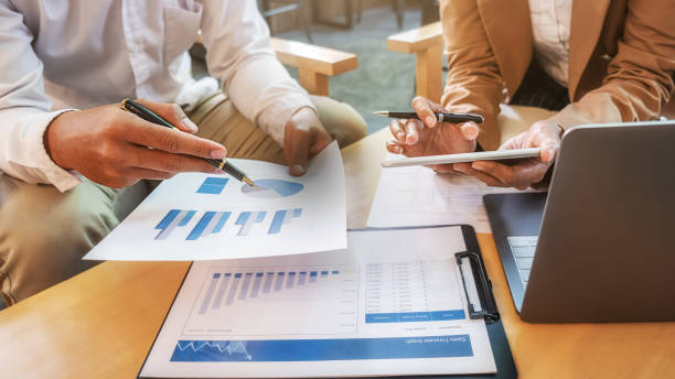 istock Business team brainstorming and discussing with financial data and report graph. Teamwork meeting working concept. 1211962601