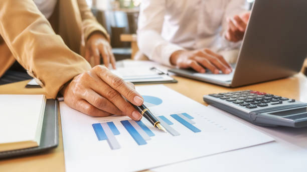 istock Business team brainstorming and discussing with financial data and report graph. Teamwork meeting working concept. 1211963275