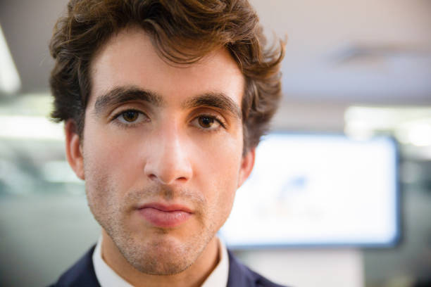 Closeup shot of handsome young man. Face of concentrated guy looking at camera. Concept of confidence