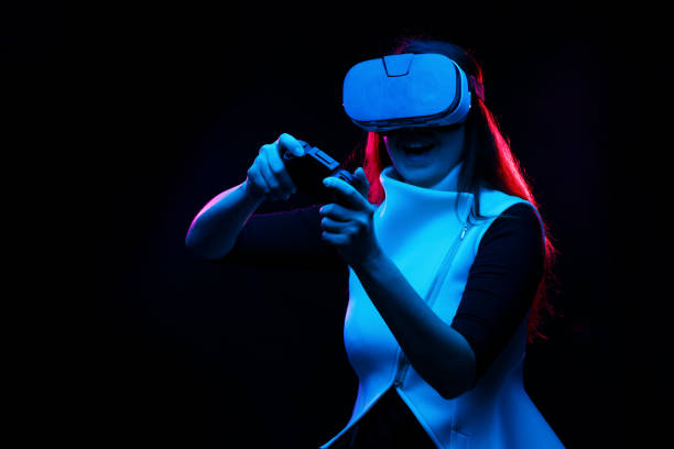 istock Woman with virtual reality headset is playing game. 1211963749