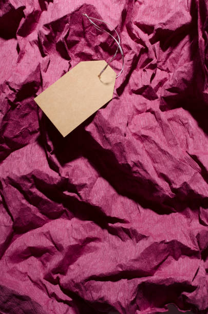 istock Empty parice tag on the crumpled tissue paper.Vertical image.Empty space for design 1211964859